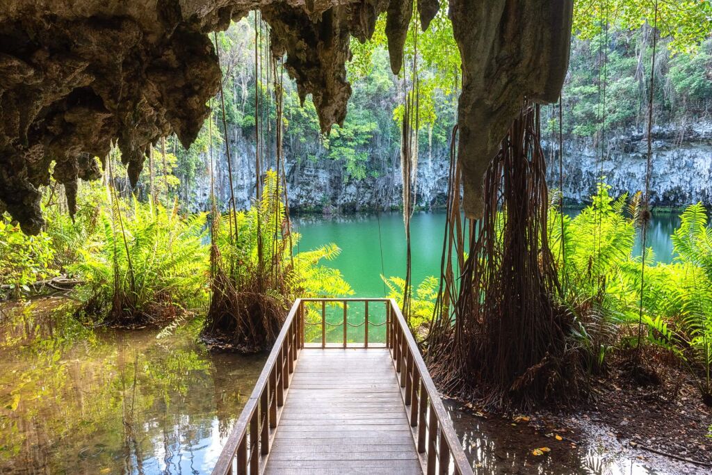 Three eyes cave in Santo Domingo, los Tres Ojos national park, Dominican Republic. Scenic view of limestone cave, beautiful lake and tropical plants, nature landscape, outdoor travel background