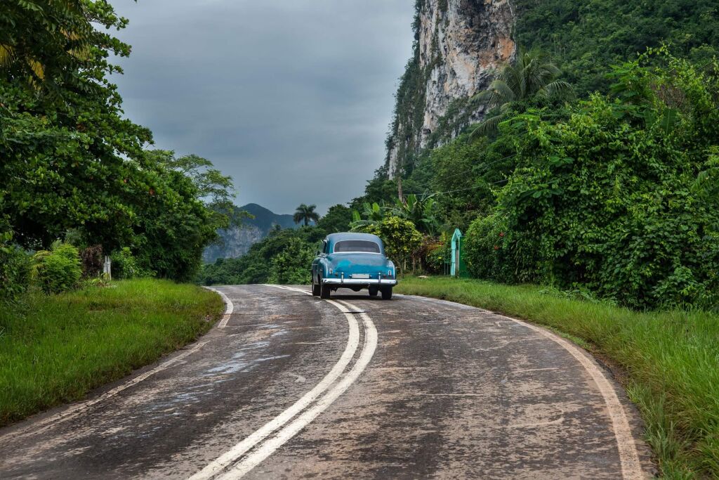 American oldtimer drive lonely on Cuban road