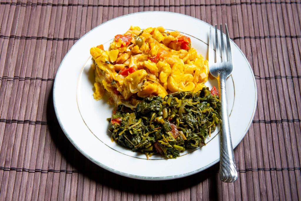 Famous traditional Jamaican ackee & saltfish  breakfast, steamed callaloo seasoned with tomatoes, thyme, onions, escallion (scallion). Popular Caribbean culture food and healthy meal/ dish in Jamaica.