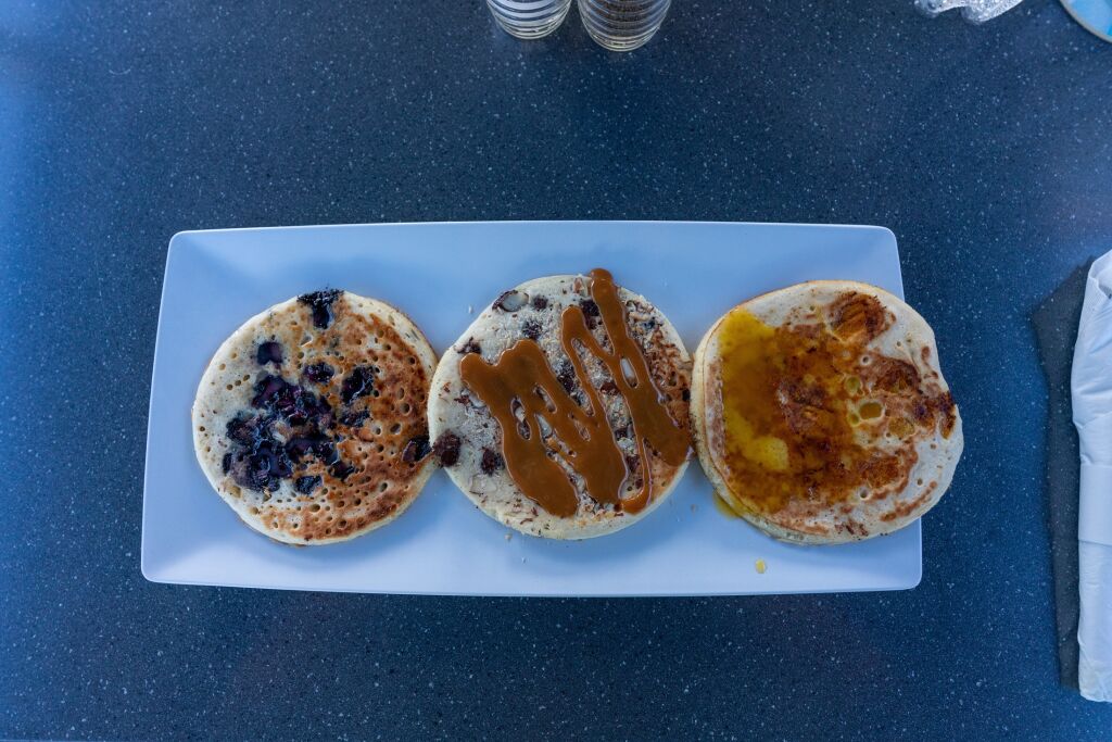 An overhead shot of three pancakes in a plate in Aruba