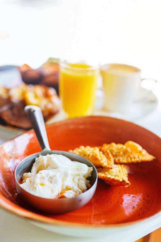 Aruba breakfast with egg casserole, cheese pastechi and orange juice