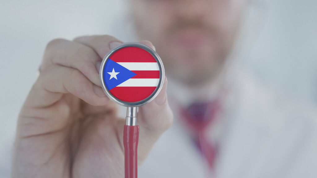 Doctor holds stethoscope bell with the Puerto Rican flag. Healthcare in Puerto Rico