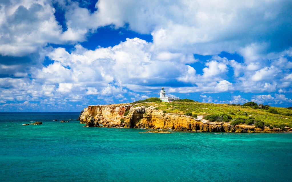 Cabo Rojo, Rojo Cabo, Puerto Rico, PR lighthouse on stunning cliffs and gorgeous turquoise blue Caribbean water. 