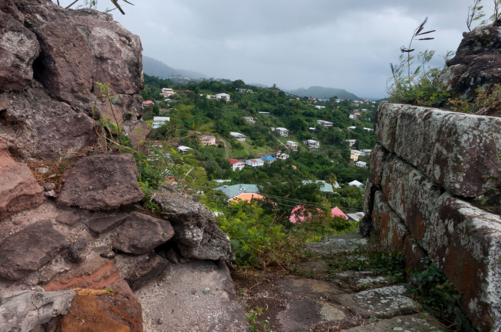 View from between the stone walls of Fort Frederick, an old Caribbean fort, to the mountains below.
