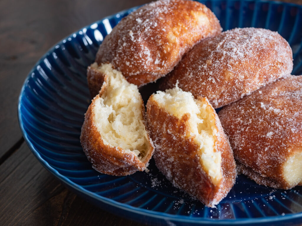 Malasada donuts. Sweet sweets made by sprinkling sugar on fried bread.